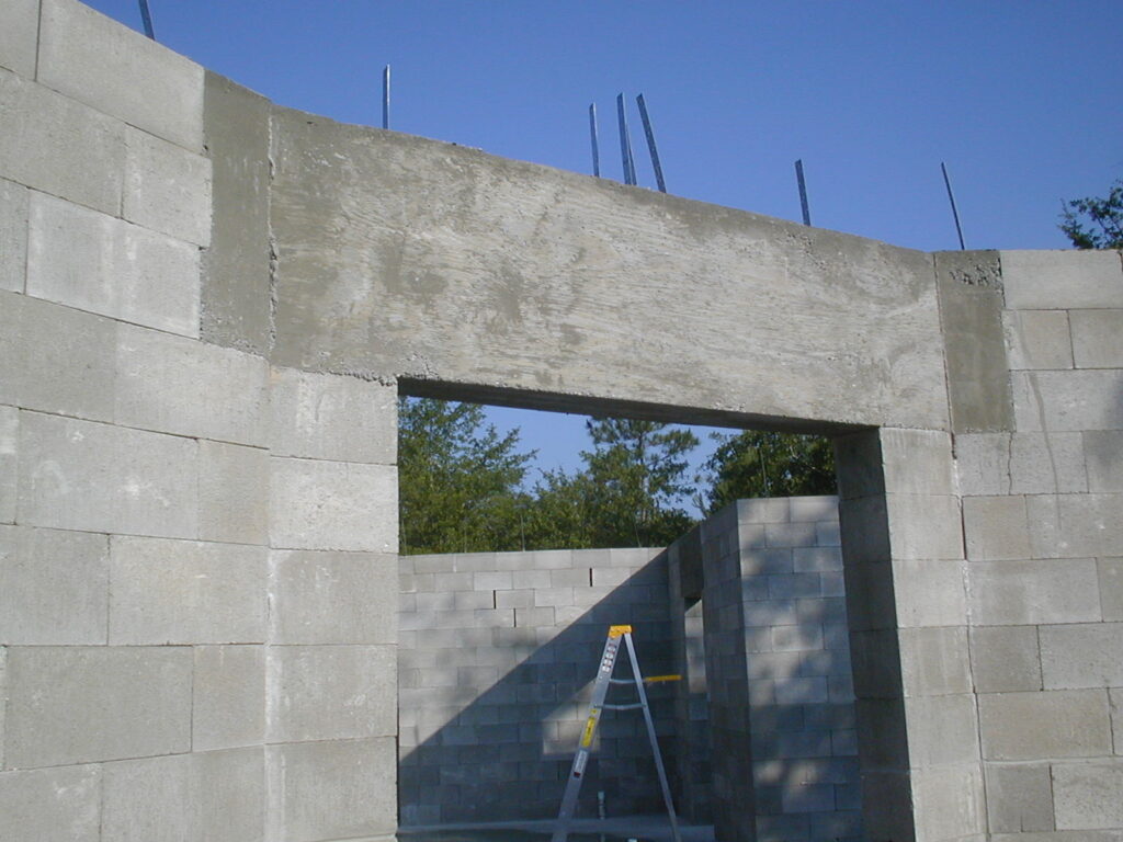 Picture of dry stacked block construction front door header after header pour.