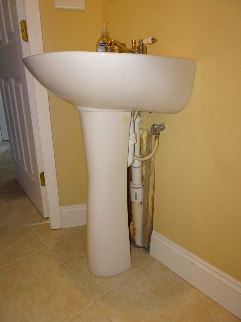 Dry stacked block pedestal sink outside wall picture.